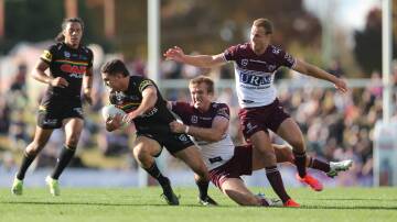Penrith star Nathan Cleary, pictured trying to avoid Manly's Jake Trbojevic and Daly Cherry-Evans at Carrington Park in 2021, will play this Saturday. Picture by Phil Blatch