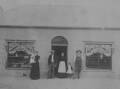 William Evans and family outside the store behind the King William Inn.
