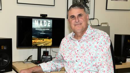 Orange-based filmmaker Vince Lovecchio in his home office with the poster from his award-nominated M.A.D.E film. Picture by Carla Freedman