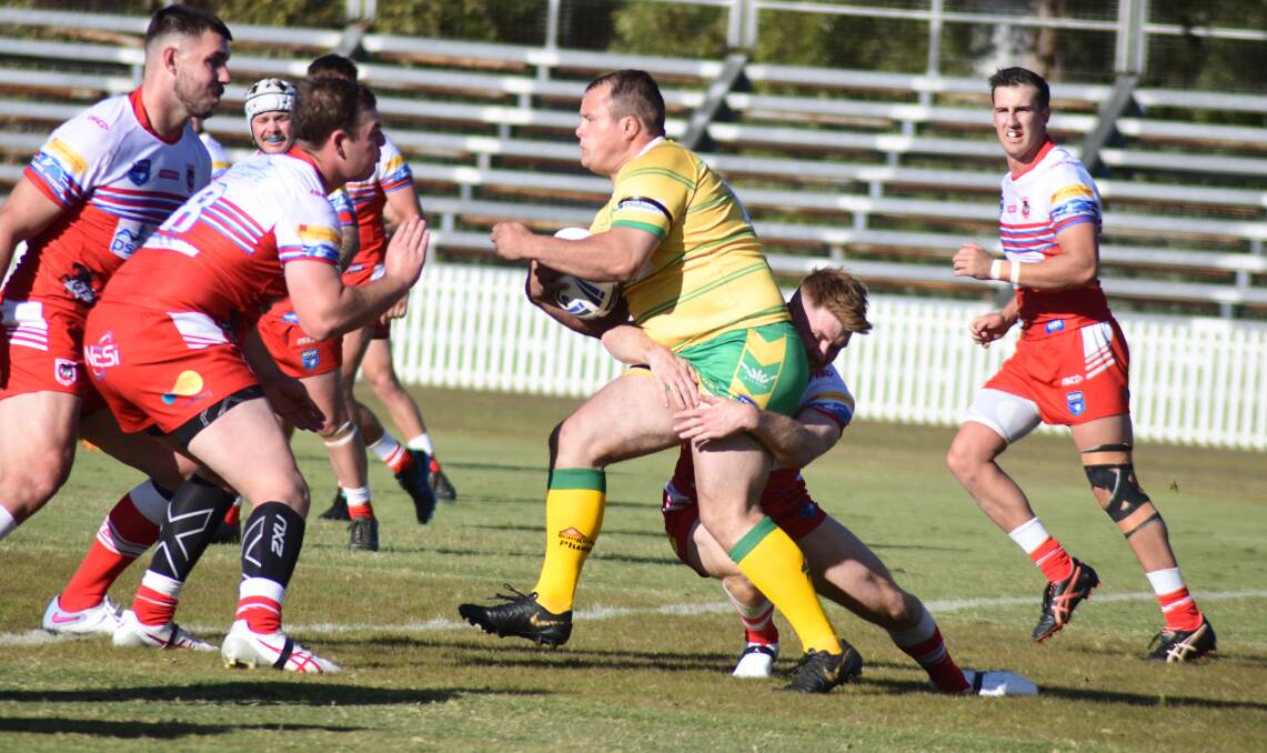 Mitch Collins takes on the Mudgee defence during Orange CYMS' round one win. Picture by Jude Keogh