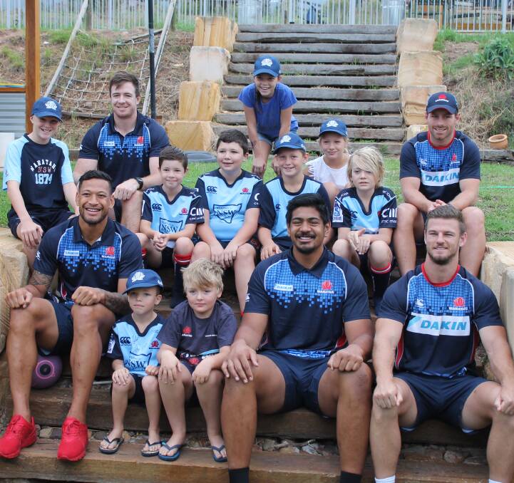 TEAM BREAKFAST: Waratahs Israel Folau, Jed Holloway, Will Skelton, Bernard Foley, and Rob Horne, take a "rugby team photo" with the lucky kids they had breakfast with on Saturday morning.