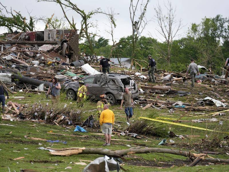 Workers search through the remains of tornado-damaged homes in Greenfield, Iowa. (AP PHOTO)
