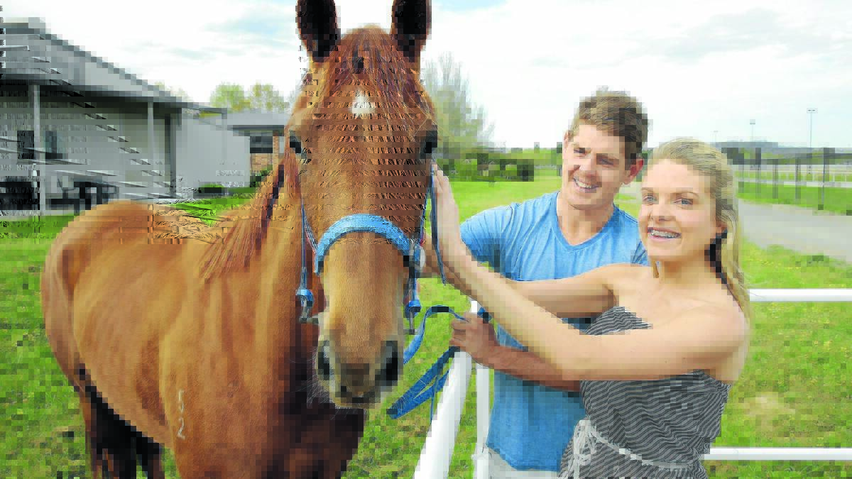 Erin Molan and boyfriend Daniel Hughes are attending the Mudgee Cup next week. They are pictured with  their two-year-old filly currently being trained at Canberra.