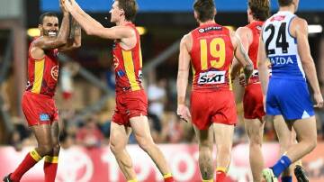 Gold Coast celebrate yet another goal during their 68-point thrashing of North Melbourne in Darwin. (Darren England/AAP PHOTOS)